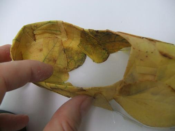 Cover the paper slipper with fall leaves 