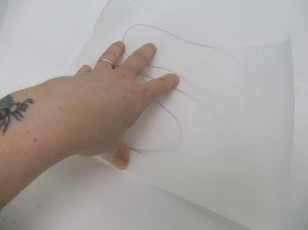 Fold the thin paper over the drawn slipper pattern