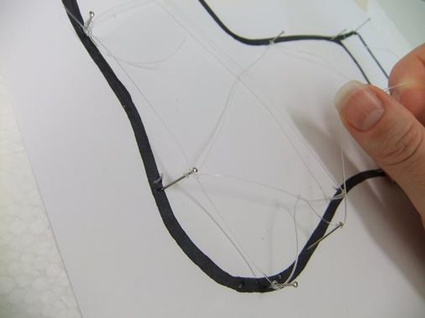 Continue stringing the line and knotting the cross-sections in a messy lace pattern Continue stringing the line and knotting the cross-sections in a messy lace pattern