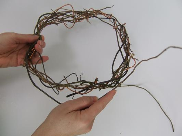 Continue weaving in willow twigs and wire to complete the wreath