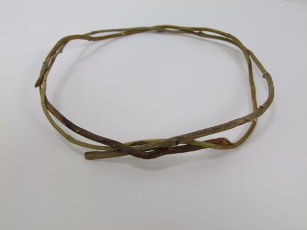 Gently bend the twig and guide it around the loop