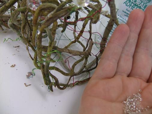 Glue in tiny ice pellet beads to add sparkle on the orchid roots.