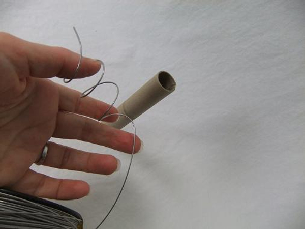 Curl the wire into a spiral by wrapping it tightly around a paper tube