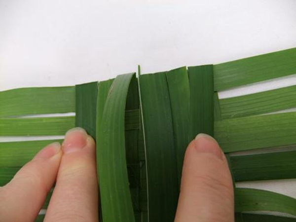 Firmly fold the palm leaves over the create a neat side