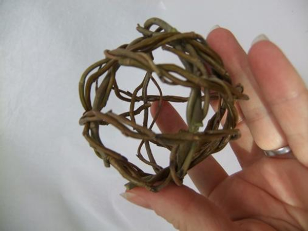Continue to build up the ball shape by placing the wreaths over the first two willow wreaths