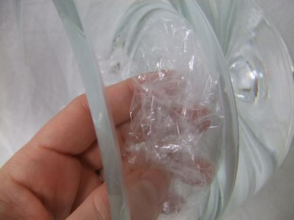Crumple cellophane or cling wrap and place in a glass container