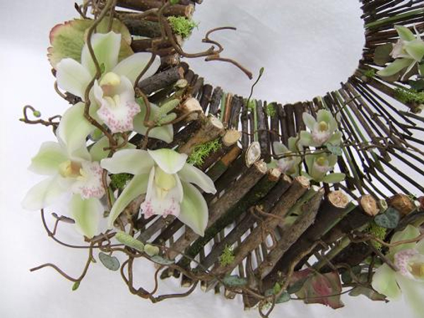 Cymbidium orchids and hazel twigs dress the handbag