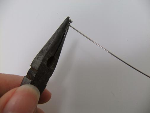 Make a hook on one end of the wire to catch the twigs