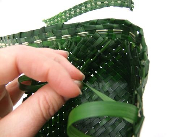 Continue stitching the trim all the way around the grass basket