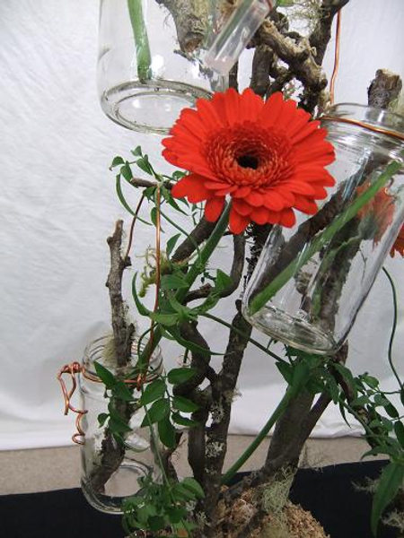 Hanging rustic copper and glass jars on the twig tree.