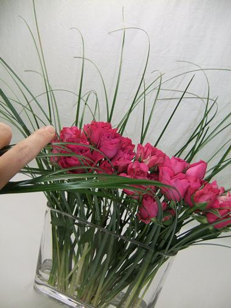 Comb the grass with your hand in the direction the french braid will be.