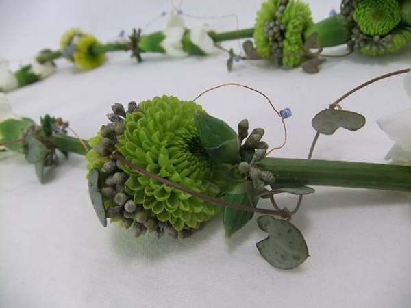 Floral lariat necklace with tiny pompon pom-poms.