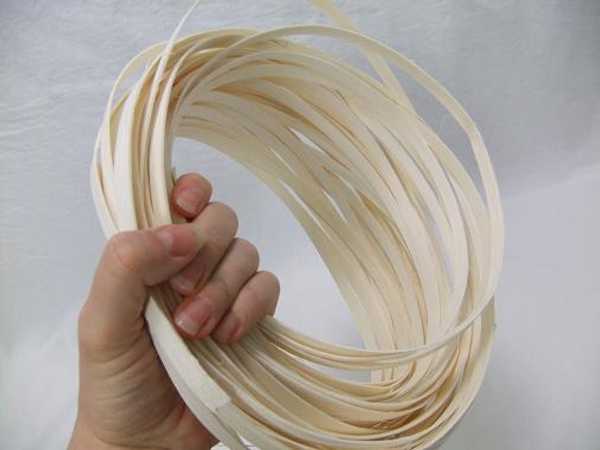 Gather a few strands of white Midelino flat coils in your hand