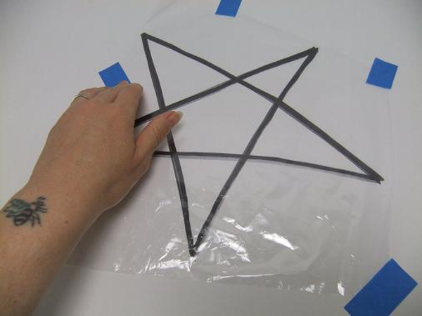 Tape clear plastic over the star drawing.