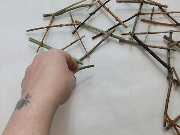 Continue to glue twigs in a round shape.