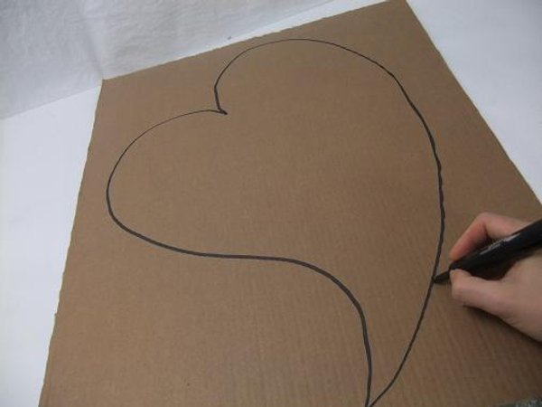 Draw a large heart shape on the cardboard.