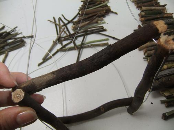 Start building up the base by threading in twigs.