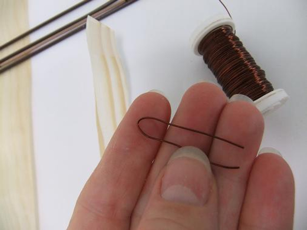 Bend a wire in half to create a hairpin.
