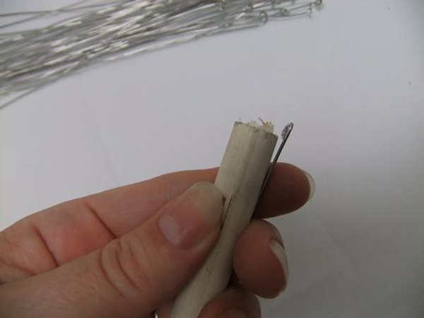 Fit the wire to the dowel and bend the spiral flat.