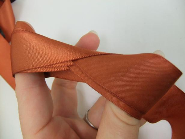 Infinity fold for storing ribbon