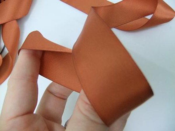 Loop the long dangling ribbon around your thumb.