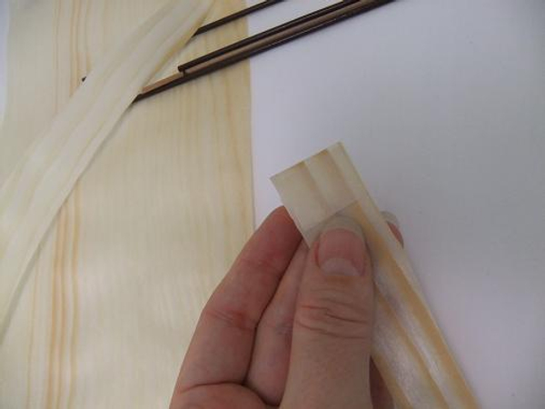 Secure a small strip of masking tape to the Kayogi paper strip.
