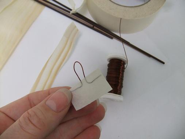 Secure the hook with a strip of masking tape.