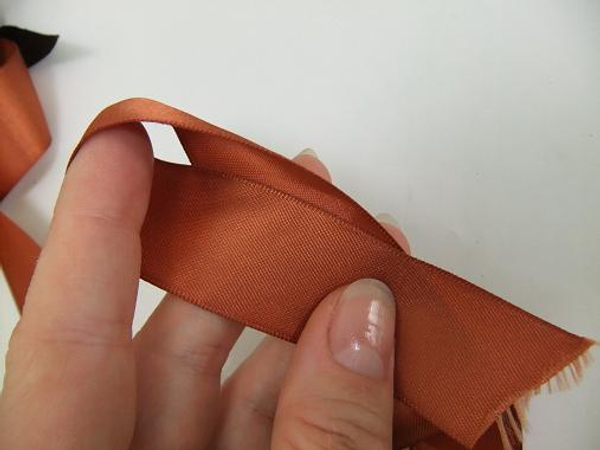 Start the infinity fold by looping the ribbon around your finger.