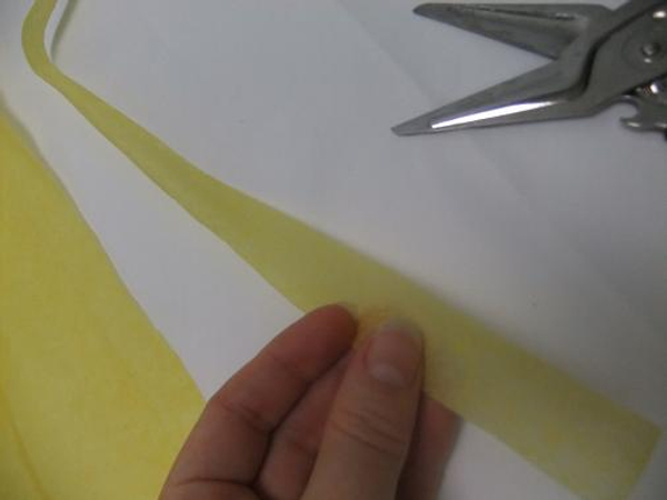 Cut a strip of yellow tissue paper.