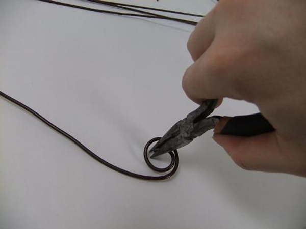 Curl the top of the first wire with pliers.