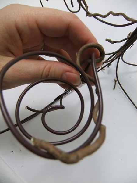 Wrap the twigs around the wire candle nest. Wrap the twigs around the wire candle nest.