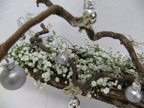 Hang a few baubles from mossy twigs.