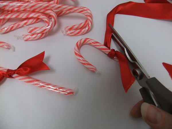 Knot a ribbon around the candy cane and dove-tail the end.