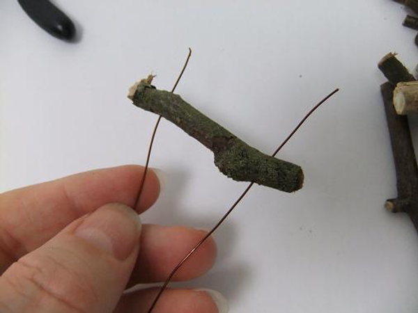 Start to thread the smaller twigs into the wire Start to thread the smaller twigs into the wire