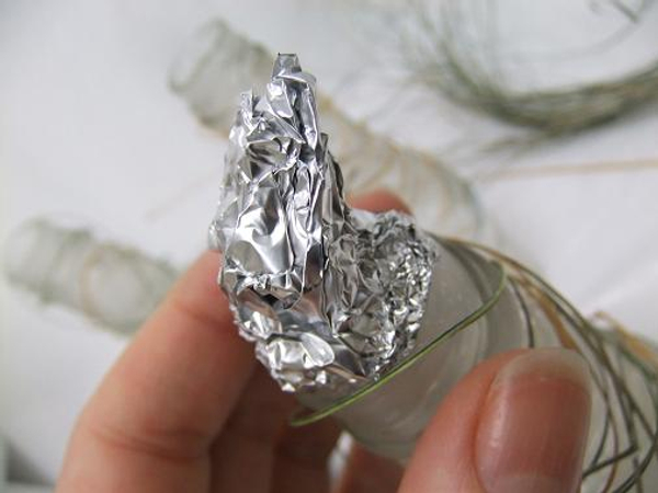 Continue to add strands all the way from the elastic band to over the foil tip