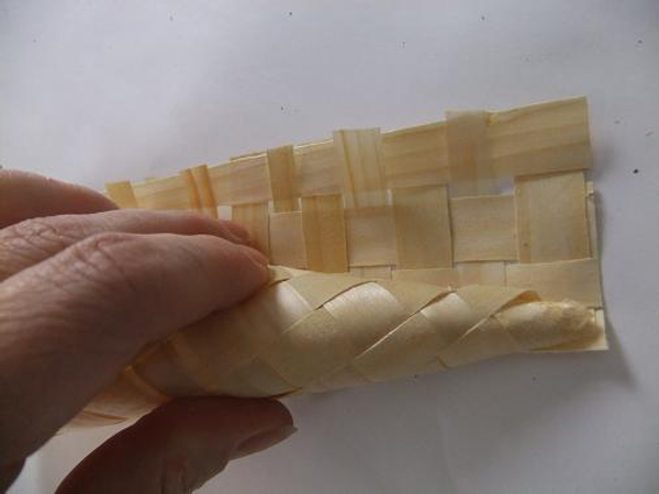 Cut the woven mat in three and tightly roll the cone shape