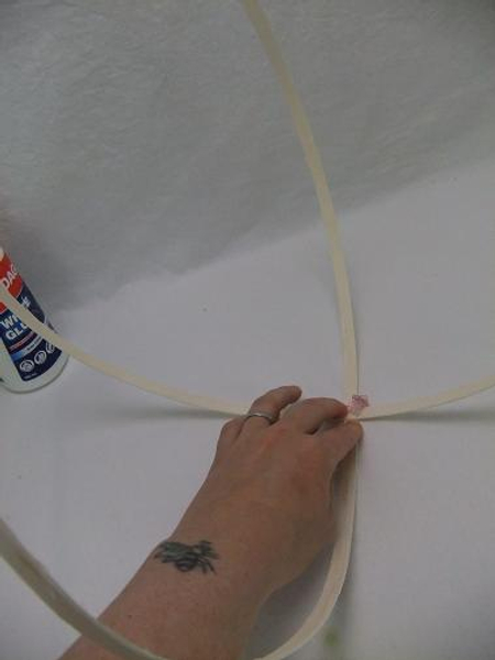 Measure out two sections of midelino cane coils and glue it in the middle point