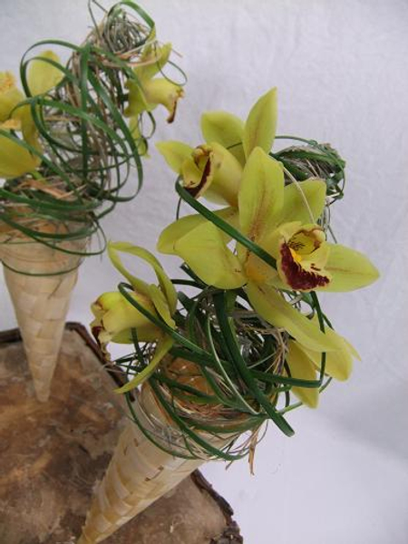 Secure the orchids by weaving in strands of ripped foliage