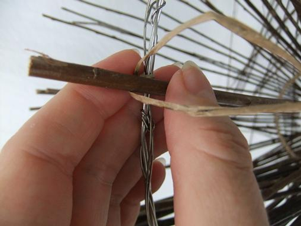 Tie the twigs to the larger wire circle