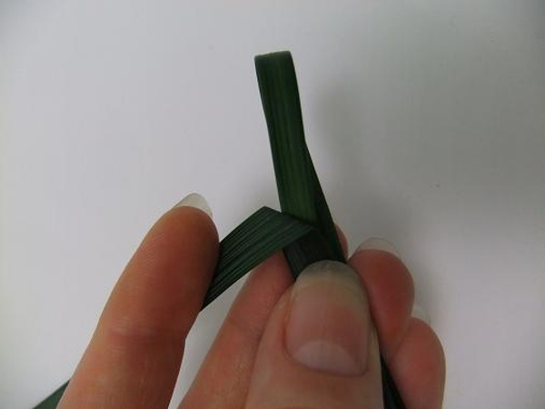 Fold the blade of grass at a sharp angle to the side.