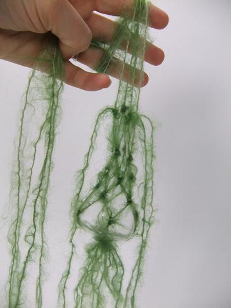 Divide the wool again and let four strands dangle down the vase