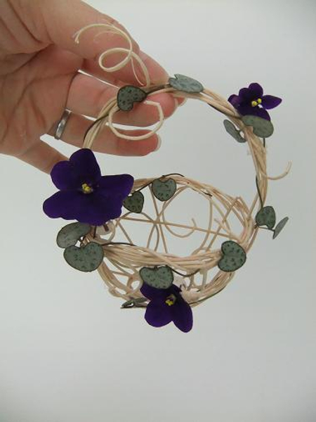 African Violets and Rosary Vine in a tiny rattan basket.