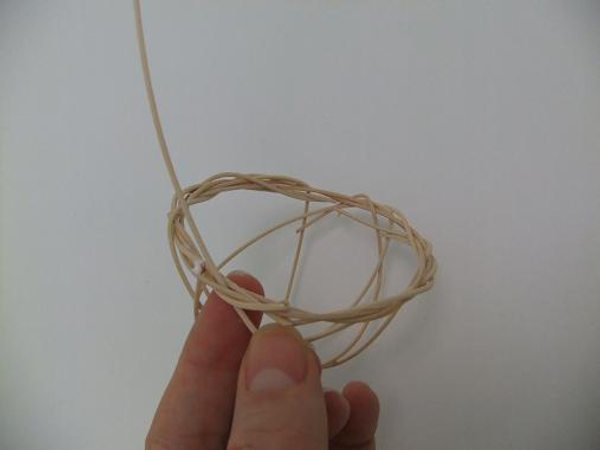 Weave in another long rattan piece to create the basket handle