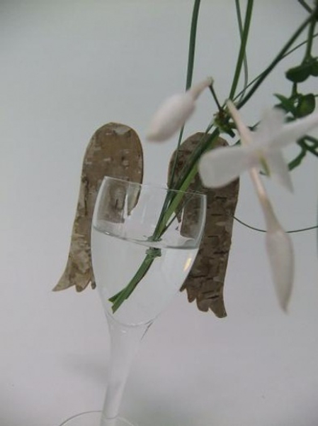 Birch bark wings hook on to the rim of a glass.