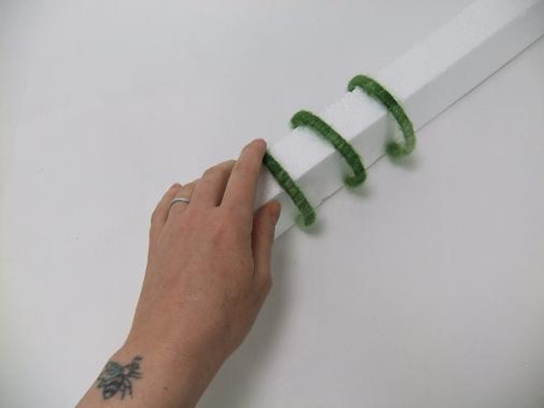 Slip the stir stick bracelets over polystyrene