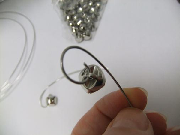 Thread a small bell through the wire Thread a small bell through the wire