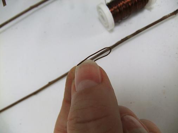 Bend a wire to pin more twigs in to place.