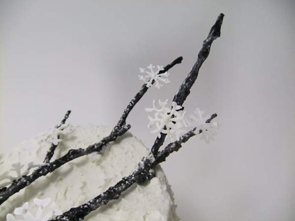 Marzipan twig and icing sugar snowflakes
