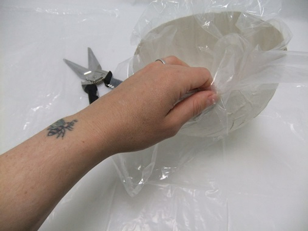 Use large sheets of plastic to line metal and paper containers for waterproofing. Use large sheets of plastic to line metal and paper containers for waterproofing.