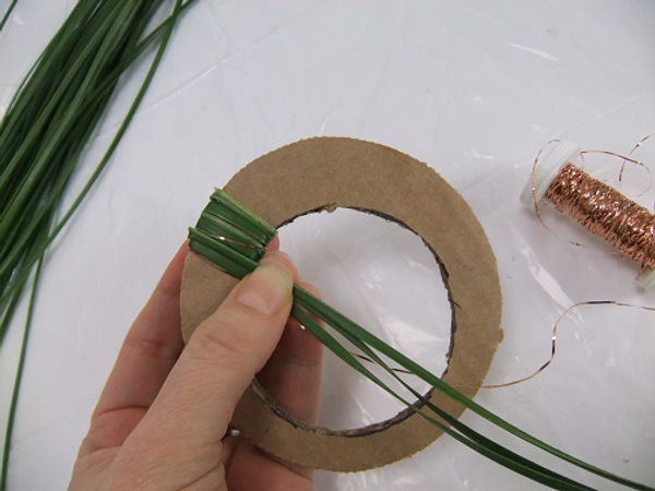 Add a bit of bulk by wrapping the strands thickly around the cardboard.